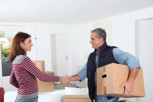 Packed moving boxes and furniture prepared for a Balham home move