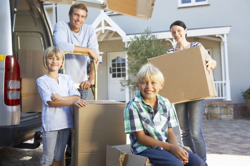 Local movers carrying items through a Balham flat staircase